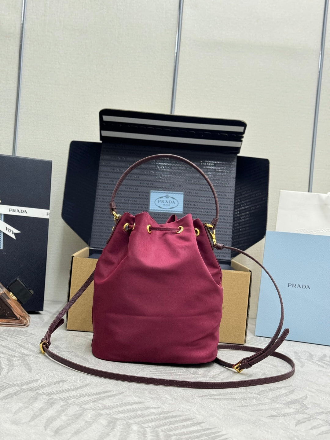 PRADA 25S DUET BUCKET BAG 23 IN BURGUNDY RE-NYLON GOLD HARDWRE