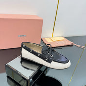 BOAT SHOES IN BLACK CALFSKIN AND WHITE CANVAS