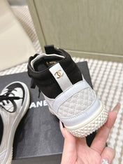 CHANEL 25S HIGH-TOP SNEAKERS IN BLACK AND WHITE CALFSKIN AND SUEDE