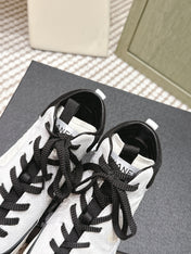CHANEL 25S HIGH-TOP SNEAKERS IN BLACK AND WHITE CALFSKIN AND SUEDE