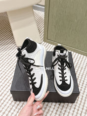 CHANEL 25S HIGH-TOP SNEAKERS IN BLACK AND WHITE CALFSKIN AND SUEDE
