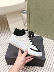 CHANEL 25S HIGH-TOP SNEAKERS IN BLACK AND WHITE CALFSKIN AND SUEDE