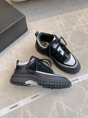 CHANEL 25S TRAINERS 40MM IN BLACK AND WHITE CALFSKIN AND SUEDE