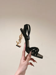 YSL 25S HIGH-HEEL SANDALS 100 MM IN BLACK GLOSSY LAMBSKIN WITH YSL LOGO HEEL DESIGN IN GOLD