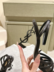 YSL 25S HIGH-HEEL SANDALS 100 MM IN BLACK LAMBSKIN WITH YSL LOGO HEEL DESIGN