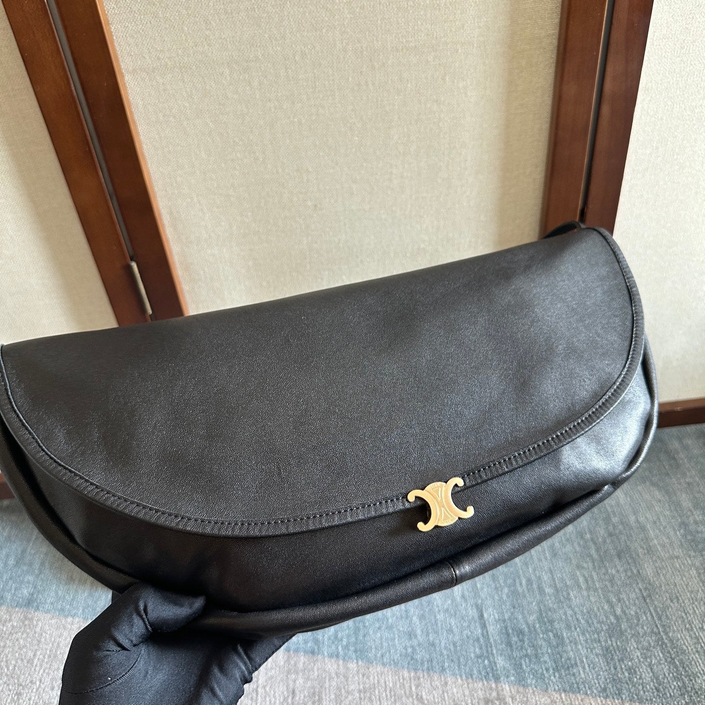 CELINE 25S HALFMOON SOFT TRIOMPHE BAG 46MM IN BLACK SUPPLE SHINY LAMBSKIN