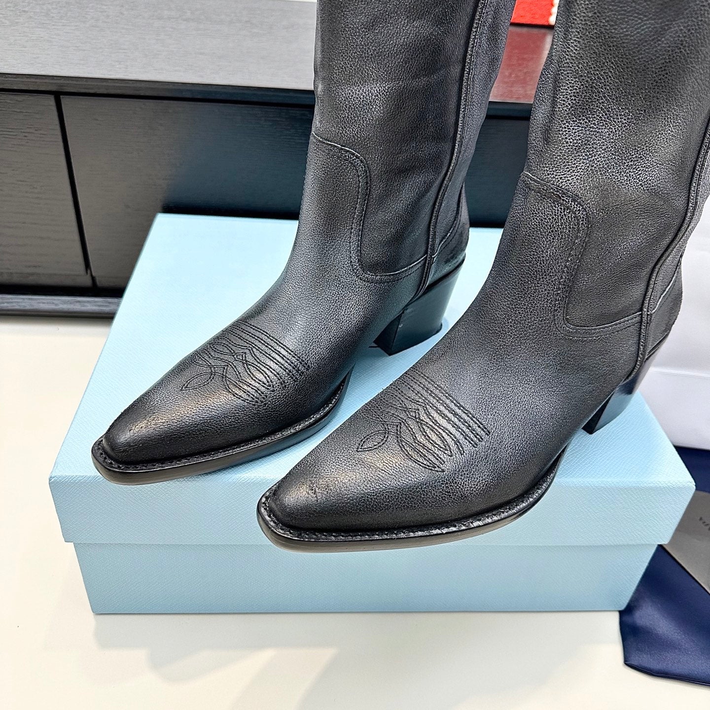 PRADA 25S POINTED-TOE LOW-CUT BOOTS IN BLACK COWHIDE