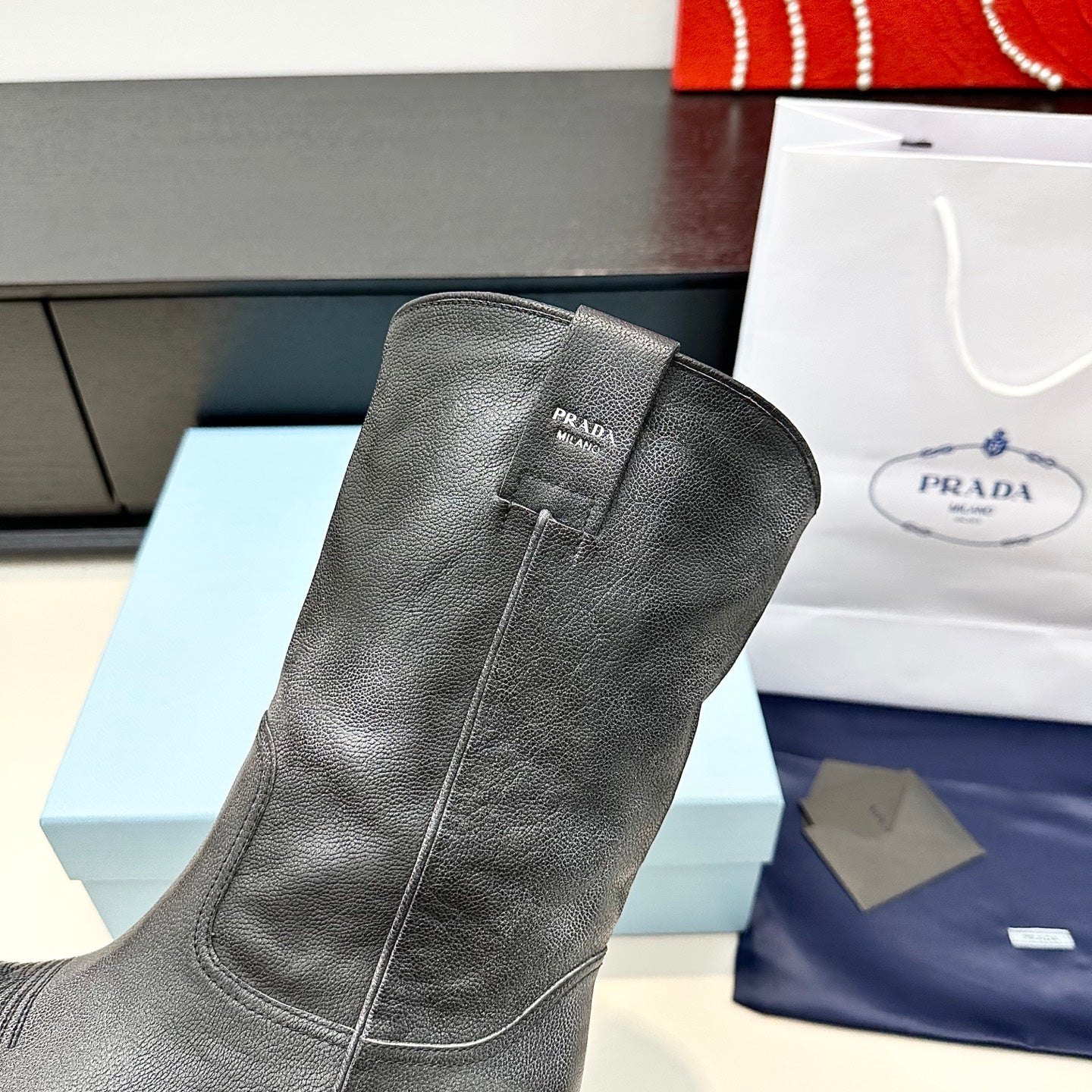 PRADA 25S POINTED-TOE LOW-CUT BOOTS IN BLACK COWHIDE