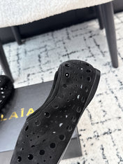 ALAIA 26S FLAT SLIP-ONS IN BLACK SUEDE WITH OPENWORK PATTERN