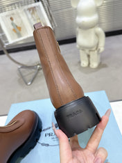 PRADA 25S ZIP-UP ANKLE BOOTS IN BROWN CALFSKIN