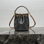 CLARA BAG 19 IN BLACK TRIOMPHE CANVAS AND BROWN CALFSKIN TRIM