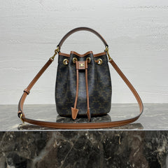 CLARA BAG 19 IN BLACK TRIOMPHE CANVAS AND BROWN CALFSKIN TRIM