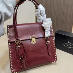 STUDDED TOP HANDLE BAG 33 IN BURGUNDY RED SMOOTH CALFSKIN
