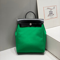 HERBAG A DOS ZIP RETOURNE BACKPACK 29 IN GREEN CANVAS AND BLACK CALFSKIN
