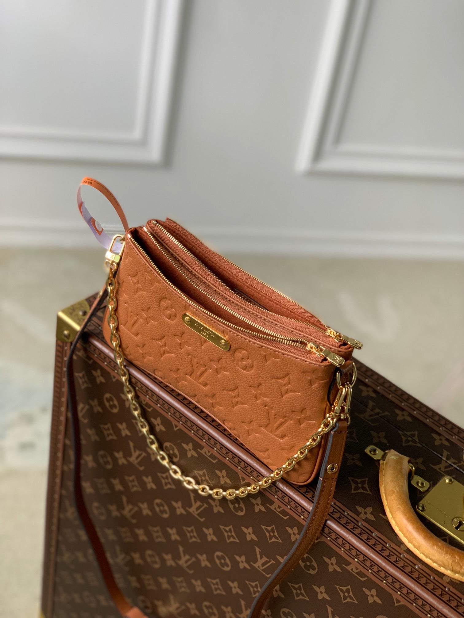 LIV POCHETTE BAG 24 IN COGNAC BROWN MONOGRAM EMPREINTE LEATHER