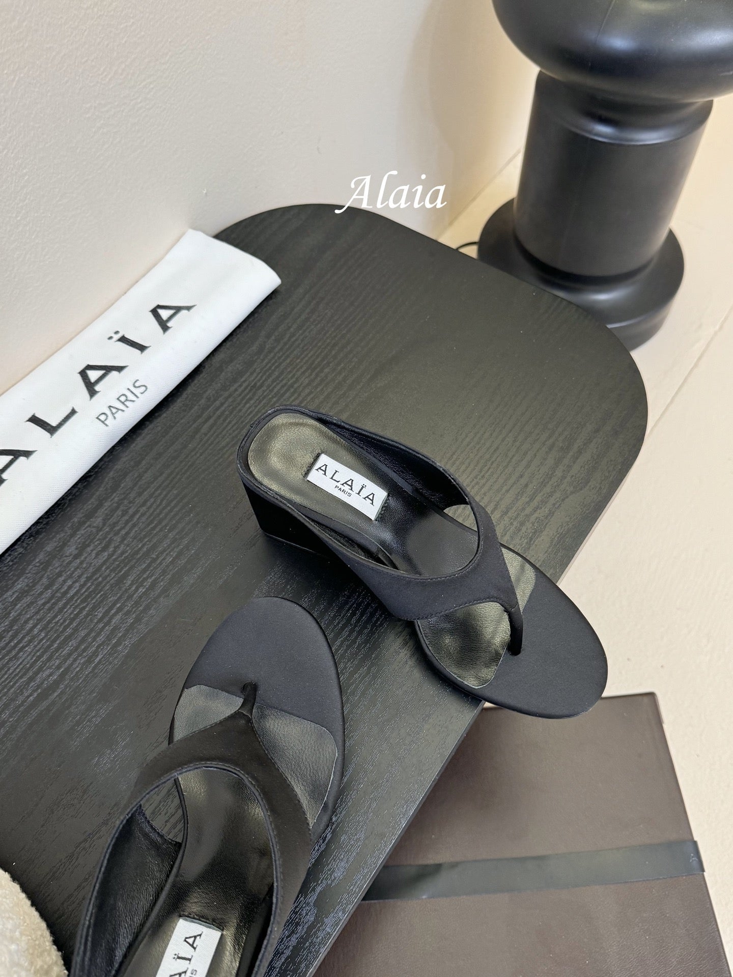 ALAIA WEDGE THONG SANDALS 25S IN BLACK SATIN