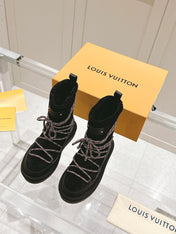 ASPEN PLATFORM ANKLE BOOT IN BLACK MONOGRAM DEBOSSED SUEDE AND SHEARLING
