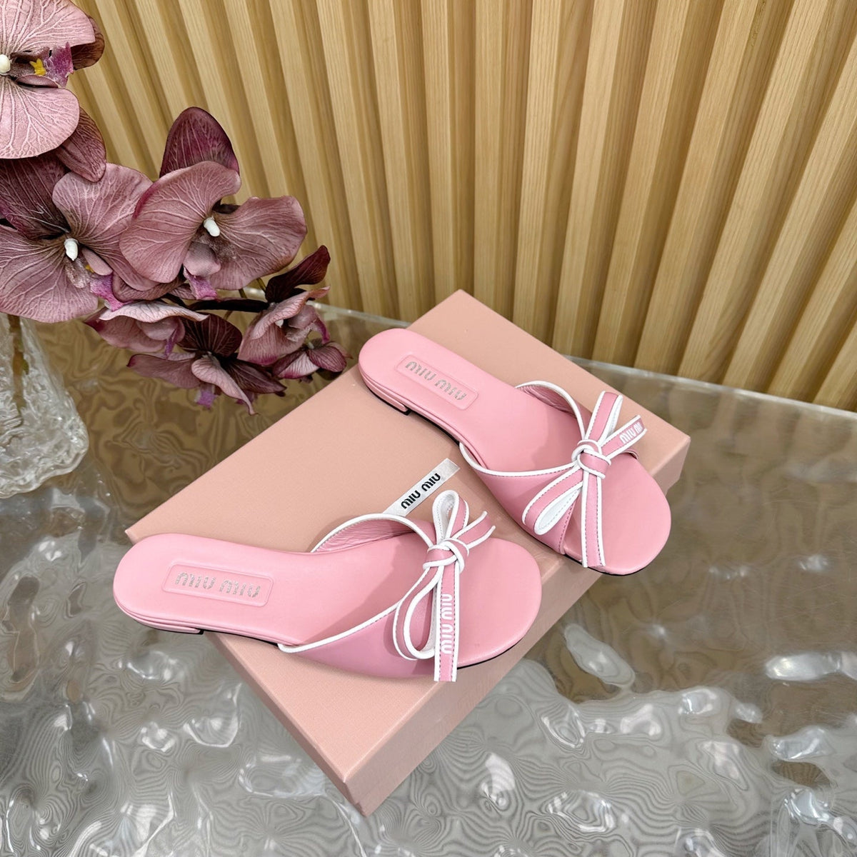 SLIDES SANDALS IN PINK CALFSKIN WITH BOW IN TRAP