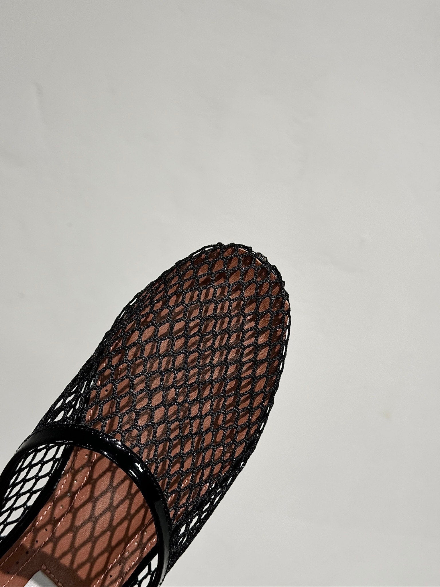 ALAIA FLAT MULES IN BLACK MESH FISHNET