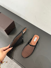 ALAIA FLAT MULES IN BLACK MESH FISHNET