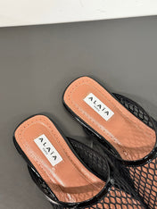ALAIA FLAT MULES IN BLACK MESH FISHNET