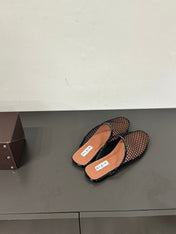 ALAIA FLAT MULES IN BLACK MESH FISHNET