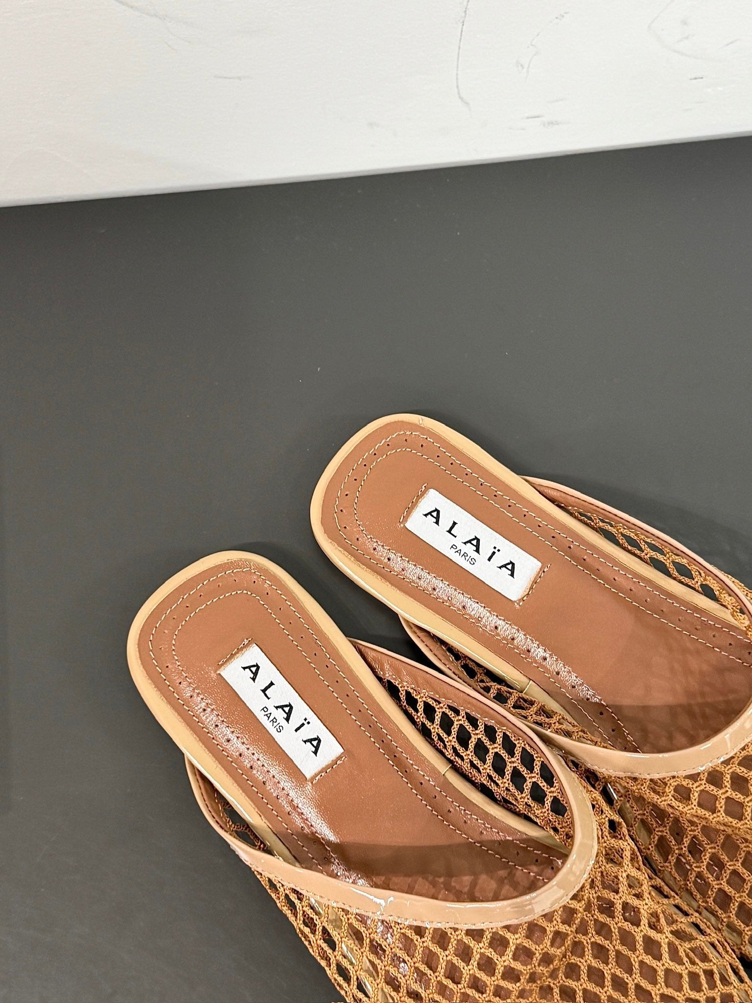 ALAIA FLAT MULES IN COPPER BROWN MESH FISHNET