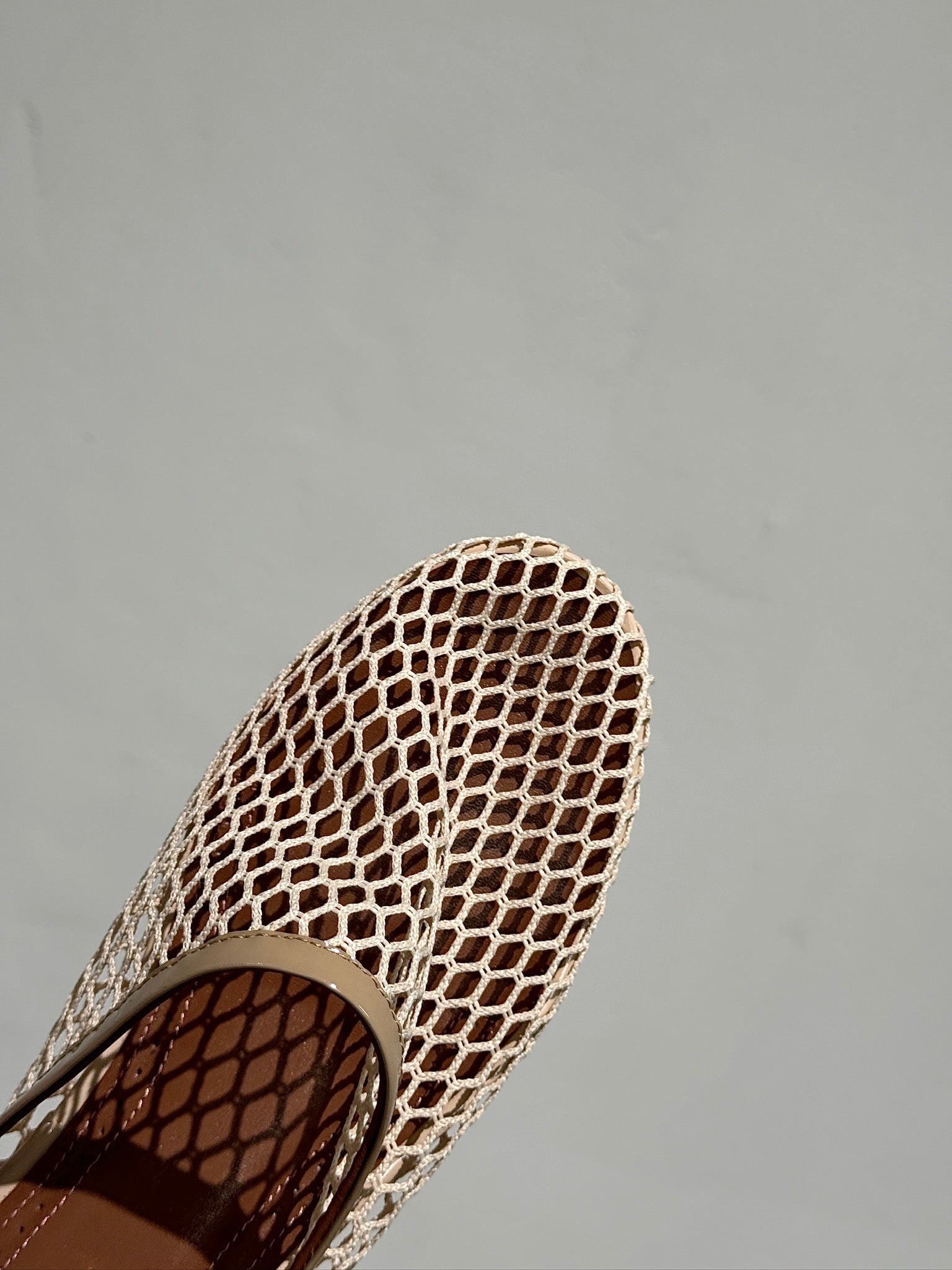 ALAIA FLAT MULES IN BEIGE MESH FISHNET