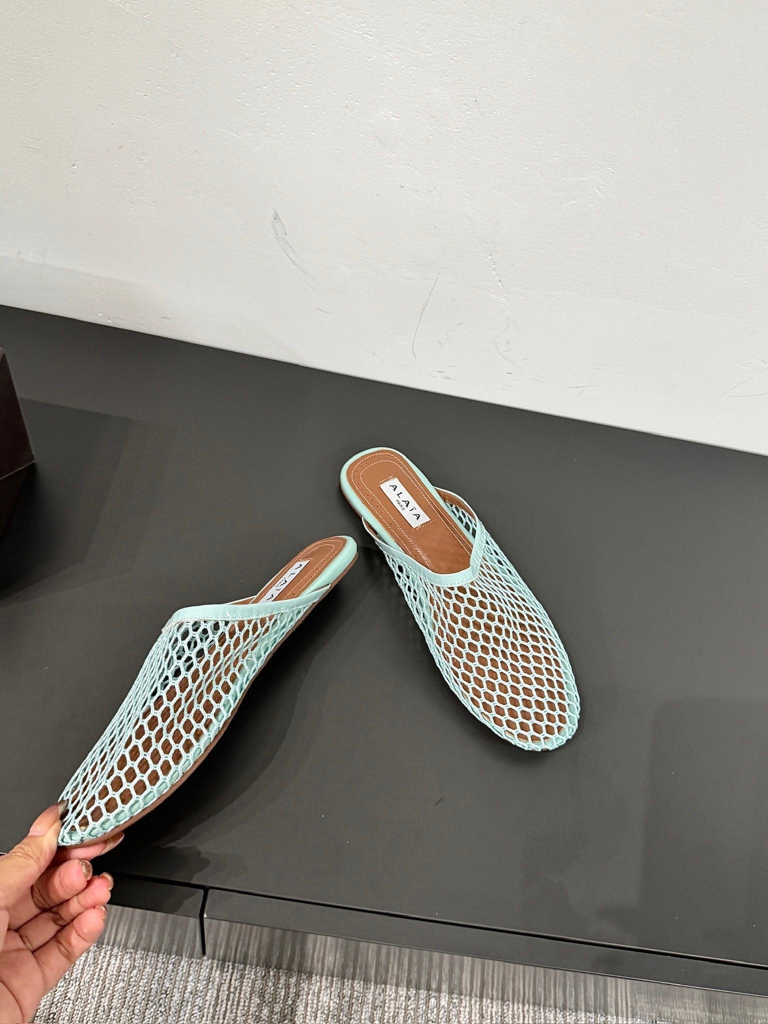 ALAIA FLAT MULES IN LIGHT BLUE MESH FISHNET