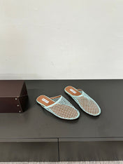 ALAIA FLAT MULES IN LIGHT BLUE MESH FISHNET
