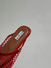 ALAIA FLAT MULES IN CHERRY RED MESH FISHNET