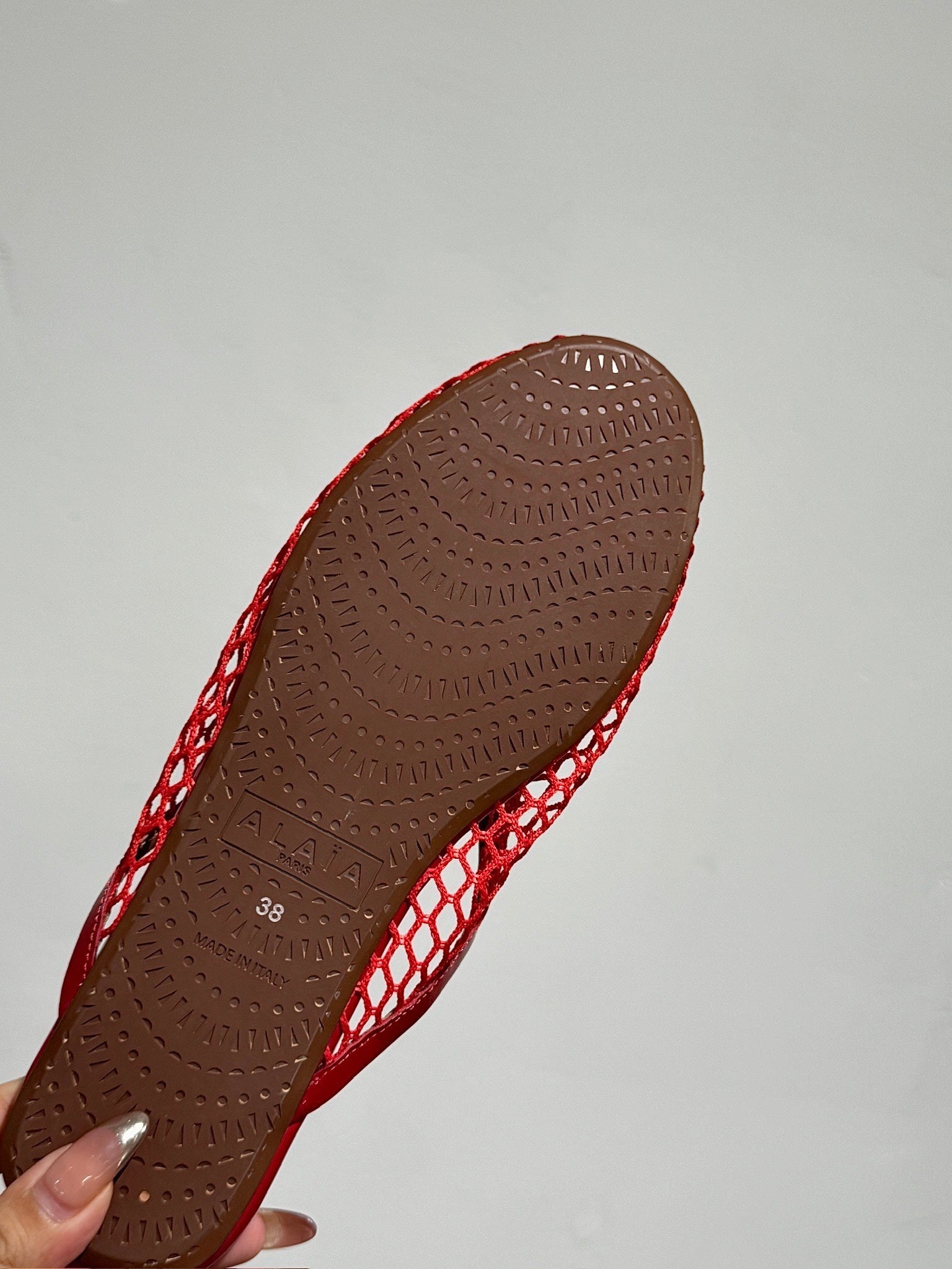 ALAIA FLAT MULES IN CHERRY RED MESH FISHNET