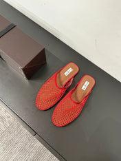ALAIA FLAT MULES IN CHERRY RED MESH FISHNET