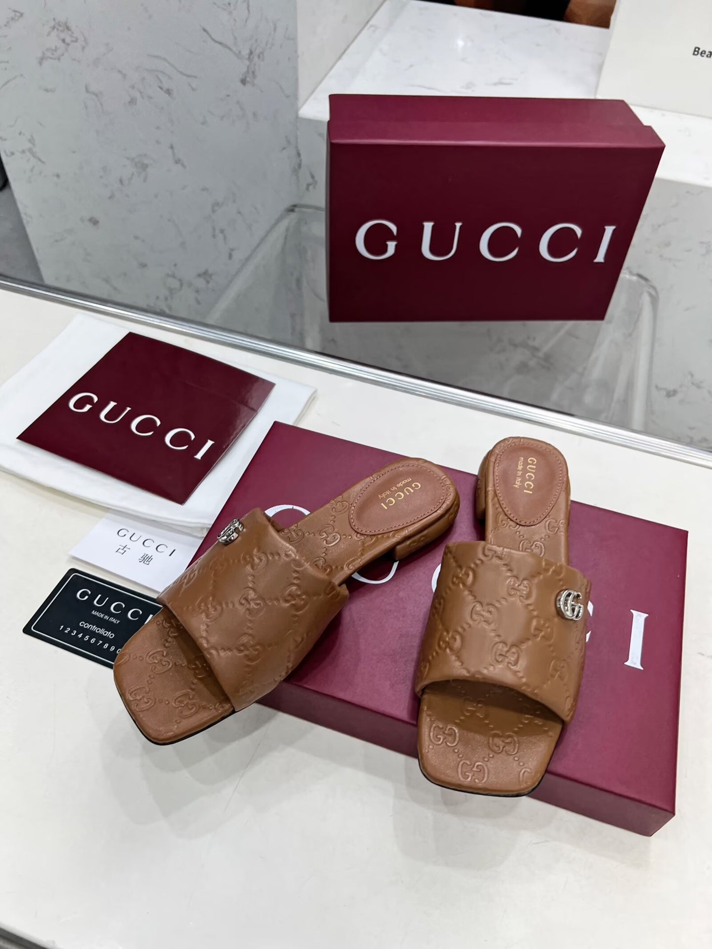 GG CASUAL SLIPPERS IN BROWN CALFSKIN LOGO EMBOSSING