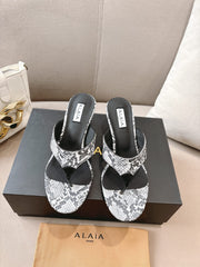 ALAIA HEELED THONG SANDALS 25S 55MM IN WHITE AND BLACK LAMBSKIN SNAKE-EMBOSSED