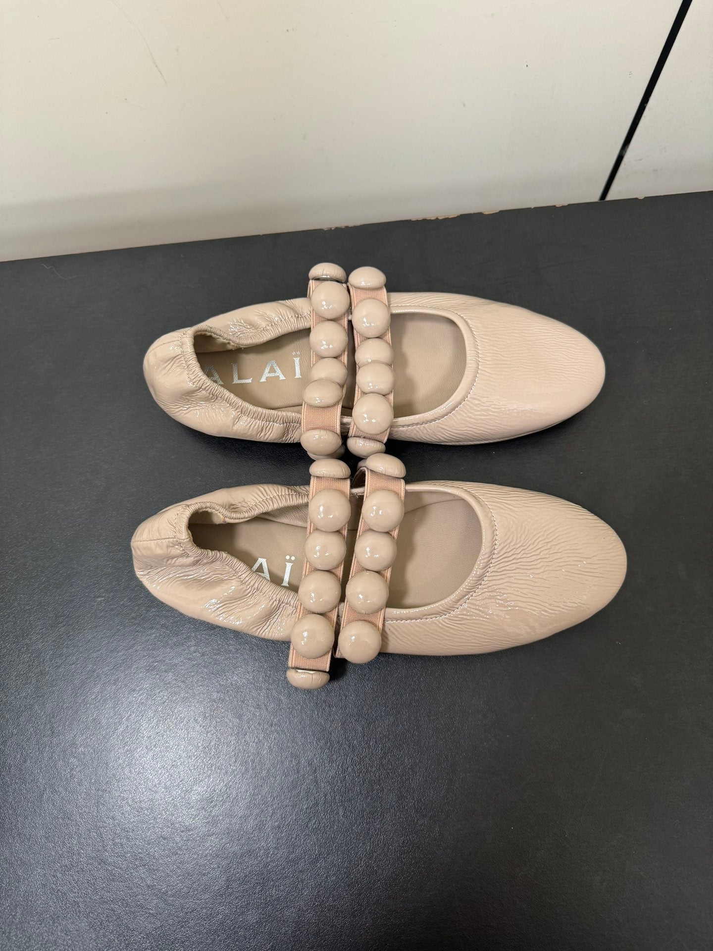 ALAIA SPHERE BALLET FLATS IN ALMOND BEIGE LAMBSKIN