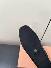 BOW MULES IN BLACK SHEEPSKIN