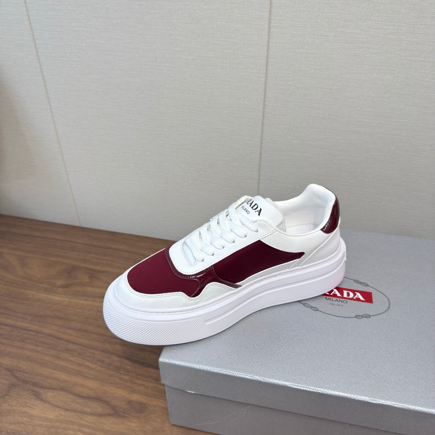 PRADA 25S DOWNTOWN BOLD SNEAKERS 45MM IN WHITE AND BURGUNDY CALFSKIN
