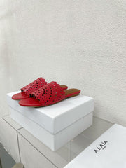 ALAIA VIENNE FLAT MULES IN CHERRY RED LAMBSKIN