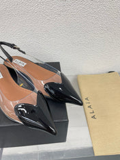 ALAIA LE COEUR FLAT SLINGBACKS IN BLACK PATENT LAMBSKIN