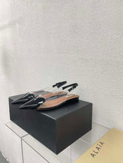 ALAIA LE COEUR FLAT SLINGBACKS IN BLACK PATENT LAMBSKIN