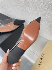 ALAIA LE COEUR FLAT SLINGBACKS IN BLACK PATENT LAMBSKIN