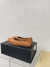 ALAIA BALLET FLATS IN COPPER BROWN CALFSKIN