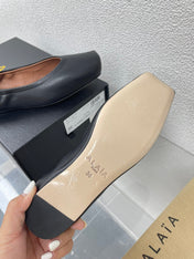 ALAIA BALLET FLATS IN BLACK CALFSKIN