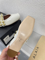 ALAIA MARY JANE PEARL IN GLOSSY WHITE LAMBSKIN