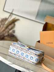 POCHETTE MÉTIS 25 IN LAGOON BLUE MONOGRAM TILES CANVAS GOLD HARDWARE