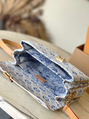 POCHETTE MÉTIS 25 IN LAGOON BLUE MONOGRAM TILES CANVAS GOLD HARDWARE