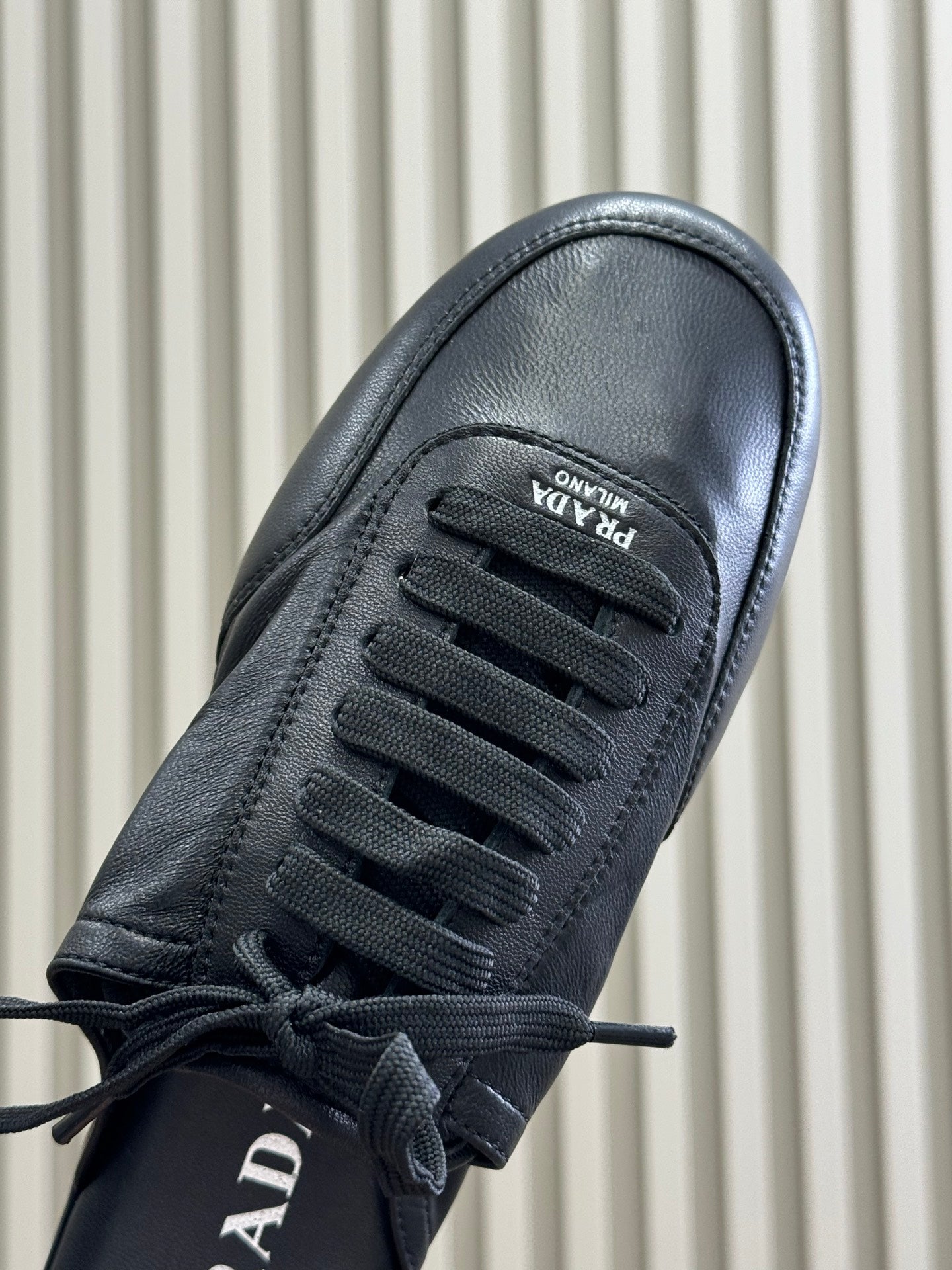 PRADA 25S COLLAPSE MULES IN BLACK CALFSKIN