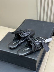 PRADA 25S COLLAPSE MULES IN BLACK CALFSKIN
