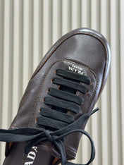 PRADA 25S COLLAPSE FLAT SHOES IN DARK BROWN CALFSKIN